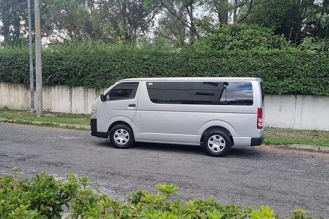 A silver minivan on a road.